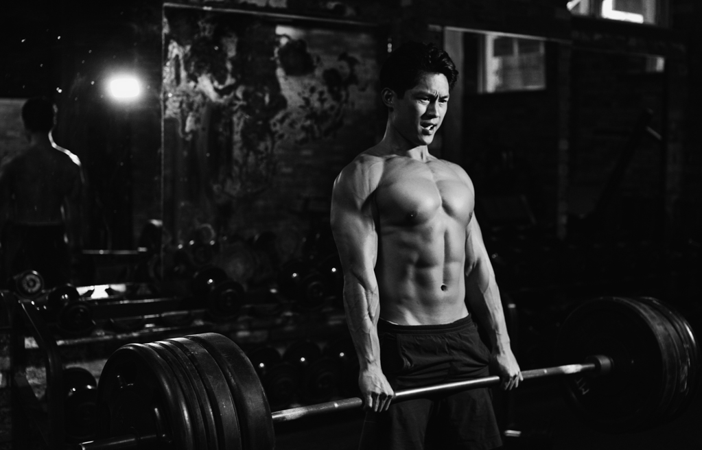 muscular man strength training 