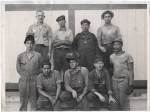 For its comfortable sturdiness, denim was a popular fabric to make workwear from. Photographed here are men working on the home front in USA during WWII, dressed in jumpsuits and overalls.